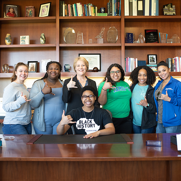 The females of the BSA stand with Dr. Miller in her office